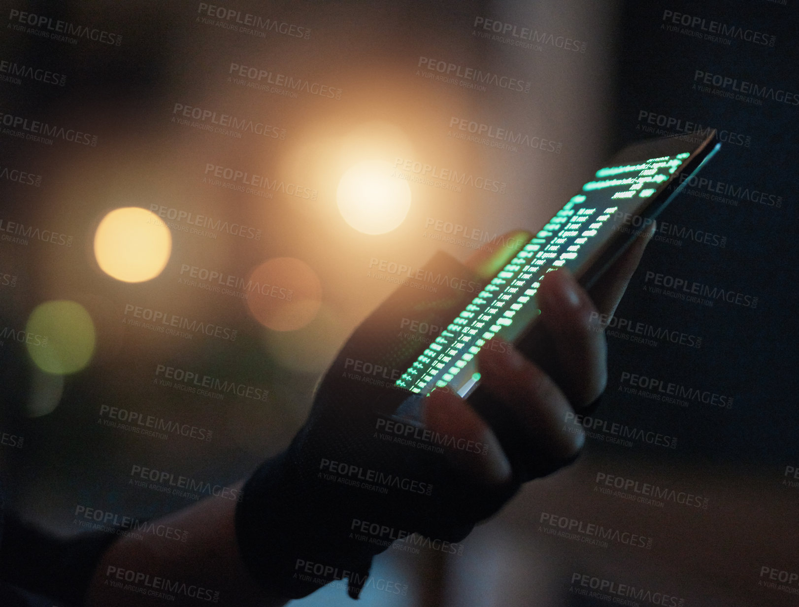 Buy stock photo Shot of an unrecognisable hacker using a cellphone in the dark