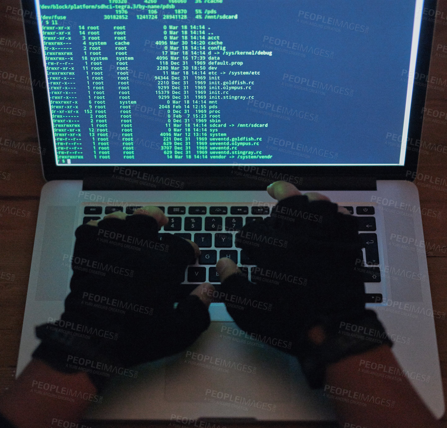 Buy stock photo Shot of an unrecognisable hacker using a laptop in the dark