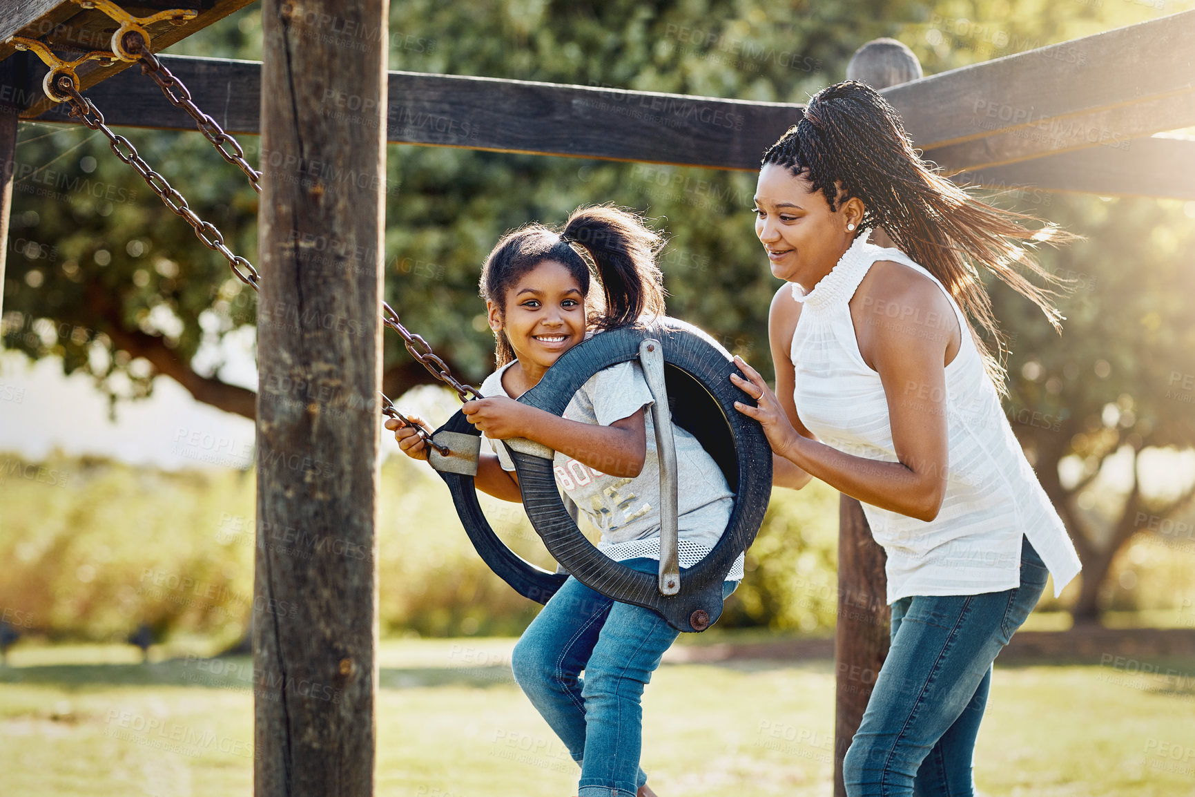 Buy stock photo Game, park swing and mother with daughter, having fun outdoor in summer for bonding or playing. Black family, child development and smile with single parent woman pushing girl kid on playground