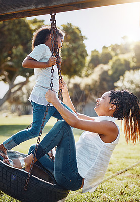 Buy stock photo Mother, daughter and happy on swing at park, fun and playing together with smile outdoor. Love, care and bonding with family happiness, woman and girl enjoy time at playground with freedom in nature
