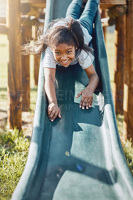 Buy stock photo Slide, playing and portrait of child in park for fun, joy or summer break in countryside. Happy, excited and girl kid on glide for obstacle equipment in outdoor field with smile for school holiday.