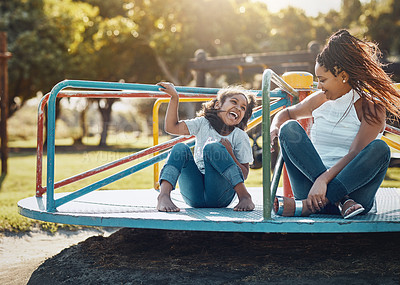 Buy stock photo Mother with daughter on roundabout at park, playing together with laughter and fun outdoor. Love, care and bonding with family happiness, woman and girl enjoying time at playground with freedom