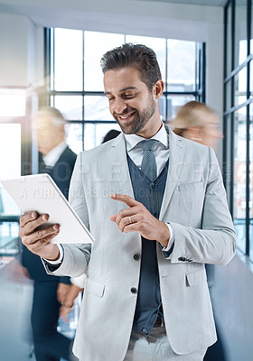 Buy stock photo Shot of an attractive, smiling businessman searching on his tablet