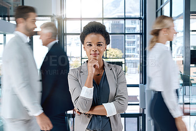 Buy stock photo Shot of a young and confident businesswoman standing, thinking and smiling in the office