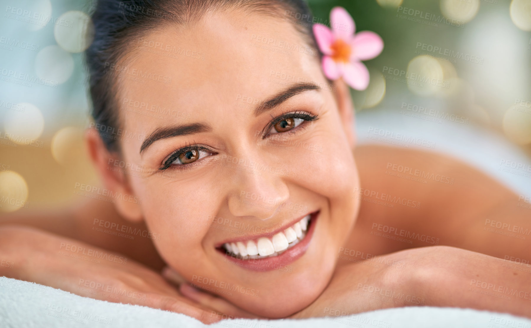 Buy stock photo Portrait of an attractive young woman relaxing on a massage table at a spa