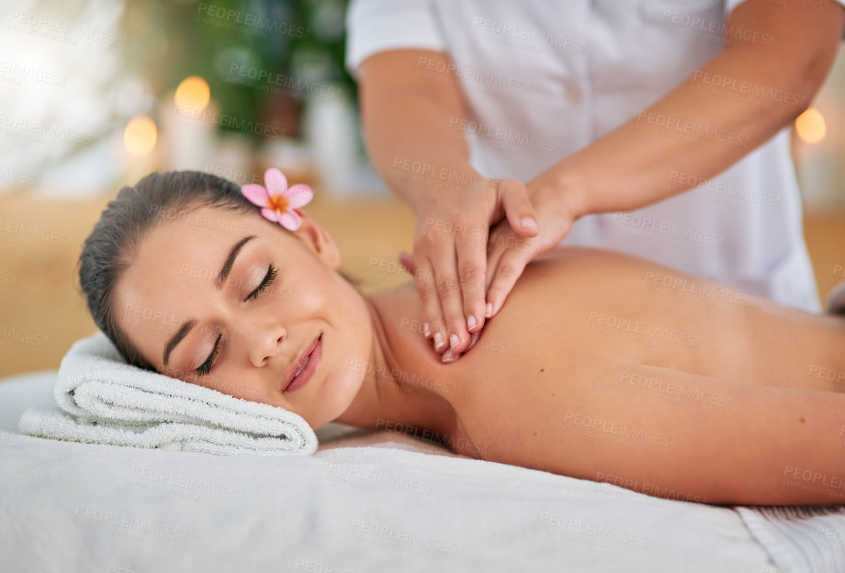 Buy stock photo Cropped shot of an attractive young woman enjoying a back massage at a spa