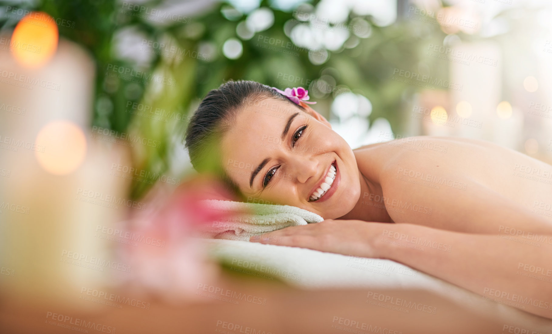 Buy stock photo Portrait of an attractive young woman relaxing on a massage table at a spa