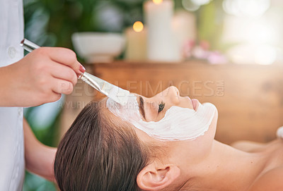 Buy stock photo Cropped shot of an attractive young woman getting a facial treatment at a spa