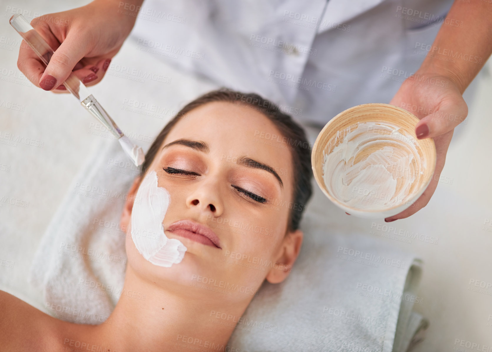 Buy stock photo Woman, skincare and application of face mask by beautician for detox, cleansing and dermatology. Esthetician, client and beauty product at luxury spa for natural clay facial, cosmetics or exfoliation