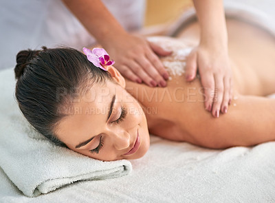 Buy stock photo Cropped shot of an attractive young woman getting an exfoliating treatment at the spa