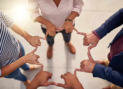 Buy stock photo Cropped shot of a group of unrecognizable businesspeople joining their hands in a gesture of unity