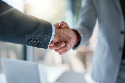 Buy stock photo Cropped shot of two unrecognizable businessmen shaking hands after making a deal in the office