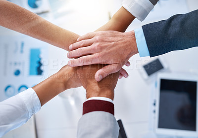 Buy stock photo Cropped shot of a group of unrecognizable businesspeople piling their hands on top of each other in the office