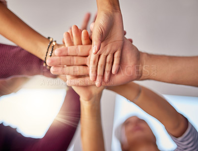 Buy stock photo Cropped shot of a group of unrecognizable businesspeople piling their hands on top of each other in the office