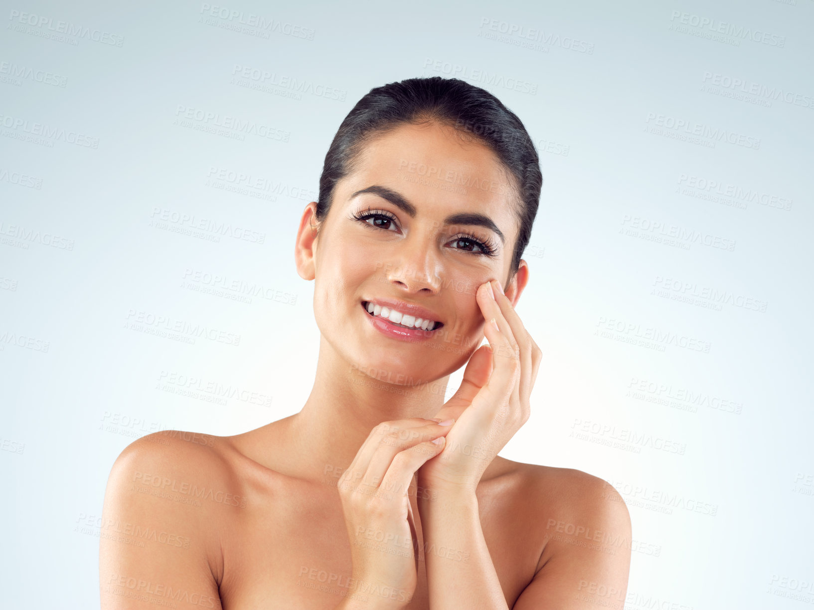 Buy stock photo Studio shot of an beautiful young woman feeling her skin against a gray background