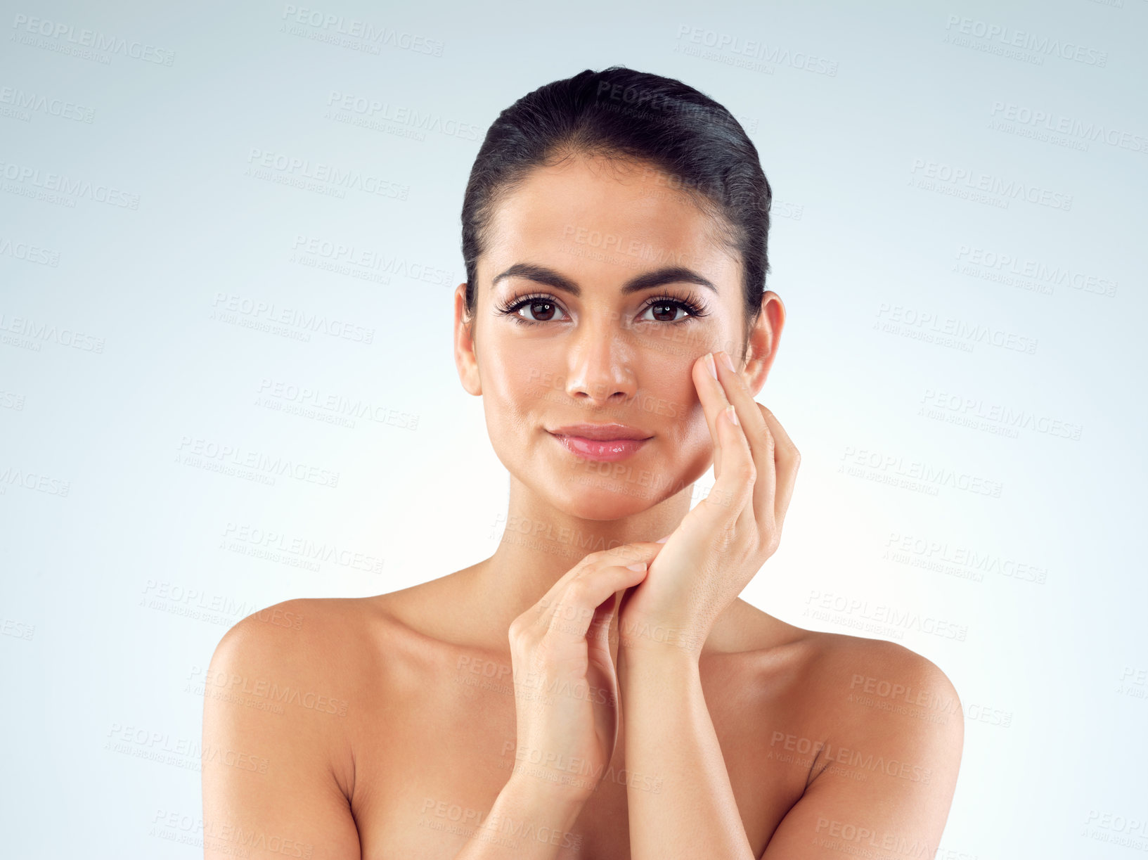 Buy stock photo Studio shot of an beautiful young woman feeling her skin against a gray background