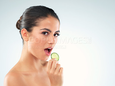 Buy stock photo Portrait, woman and eating cucumber for skincare isolated on white studio background mockup. Face, beauty and model with vegetable for healthy diet, nutrition and natural organic food for wellness