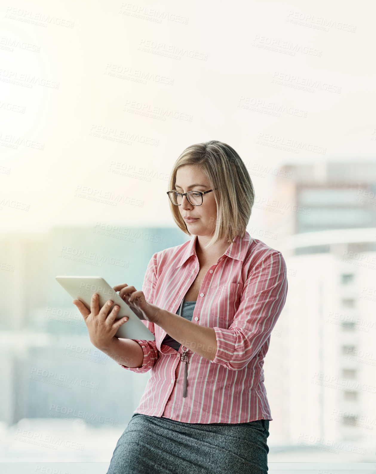 Buy stock photo Cropped shot of a businesswoman using a digital tablet in an office