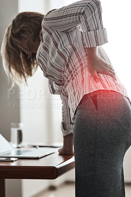 Buy stock photo Shot of a businesswoman suffering with back pain while working in an office