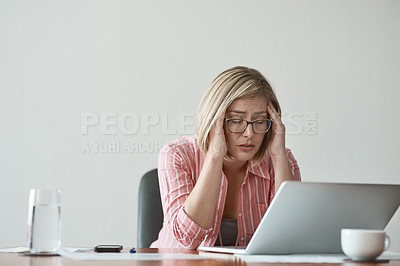 Buy stock photo Studio shot of a businesswoman looking stressed out while working on a laptop against a grey background