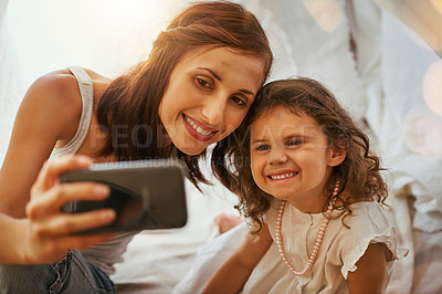 Buy stock photo Happy, woman and child with selfie in home for bonding, love or memory of childhood together. Smile, mother and daughter with digital photography in bedroom for online post, media or update to family