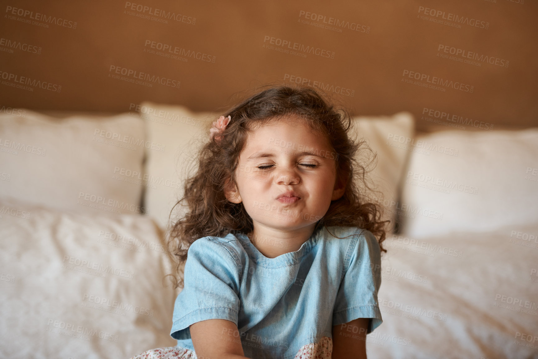 Buy stock photo Playful, kiss and face of child in bedroom with adorable, cute and innocent facial expression. Childhood, home and young girl on bed with emoji, pout and silly pose for playing, fun and confidence