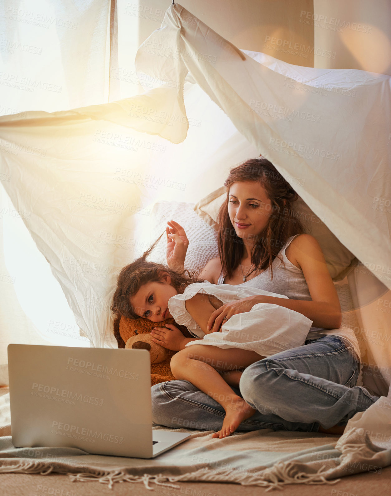 Buy stock photo Shot of a mother and daughter bonding and watching a movie on a laptop in the bedroom