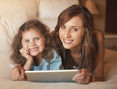 Buy stock photo Portrait, mom and child with tablet, bed and bonding with internet, education and love in home. Digital app, woman and daughter together in bedroom for online streaming subscription, movies and relax