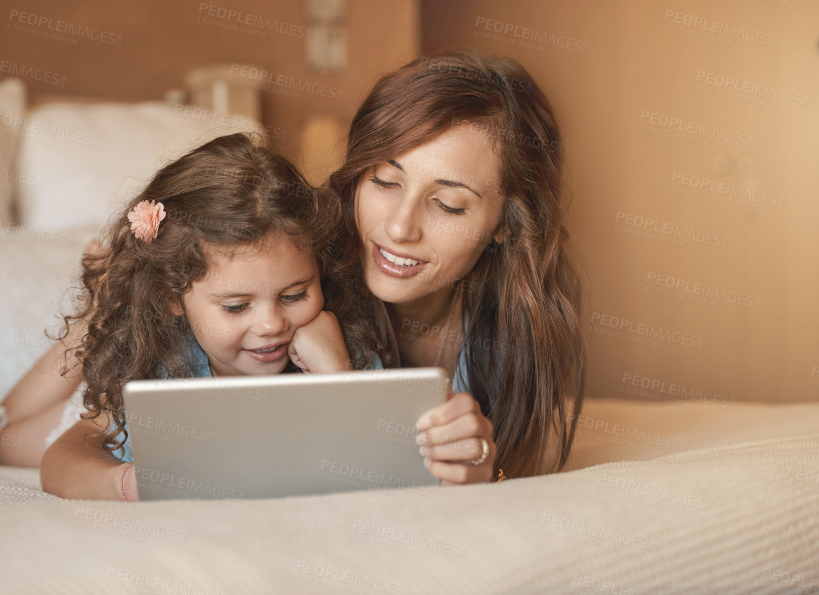 Buy stock photo Bed, mom and child with tablet, reading and bonding with ebook, education and love in home. Digital app, woman and daughter together in bedroom for online streaming subscription, movies and relax