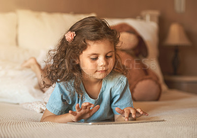 Buy stock photo Girl, child and tablet in bedroom, reading or watch video for streaming, click or subscription on web. Kid, relax and digital touchscreen in family house for movie, film or application in New Zealand