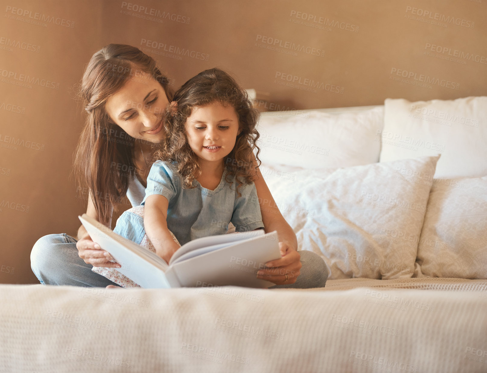 Buy stock photo Girl, mom and happy with reading on bed with care, bonding and love with connection for learning in house. Storytelling,  mother and daughter with book listening or teaching in bedroom at family home