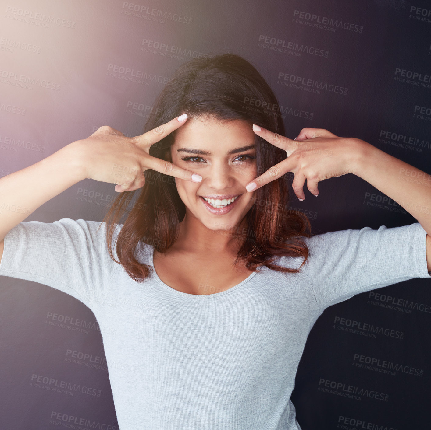 Buy stock photo Studio, portrait and happy woman with peace sign, cool emoji and hand gesture on face for expression. Smile, confident girl model and edgy student in Italy with casual teenager with dark background