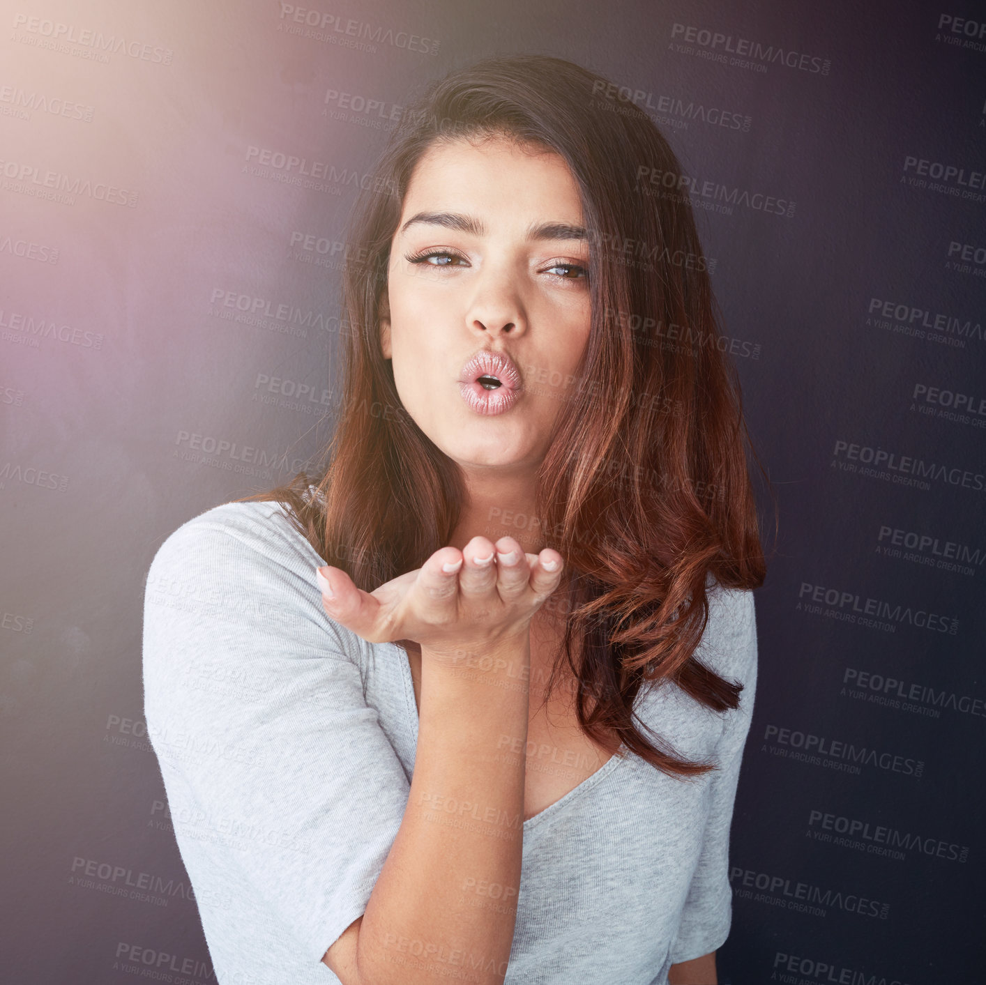 Buy stock photo Woman, portrait and blowing kiss on studio background, flirting and romance or love gesture. Female person, care and air kissing for emoji or confident for affection, backdrop and valentines day date