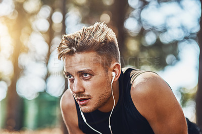 Buy stock photo Man with earphones, breathing after running in forest and fitness with music, listening for motivation on run in park. Male runner outdoor, rest with podcast or radio streaming, exercise and cardio