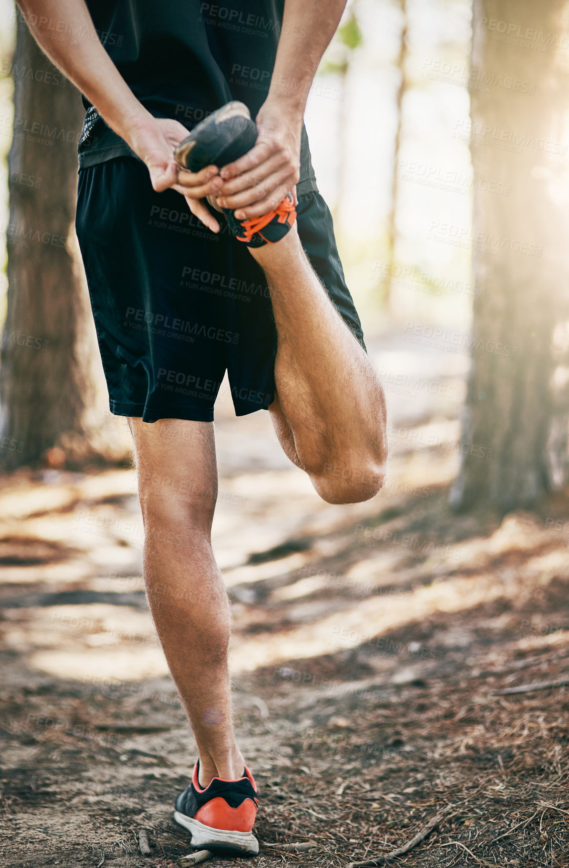 Buy stock photo Man, nature and stretching legs for warm up, runner and training in woods for fitness in routine. Male person, back and flexibility for muscle or athlete for wellness, forest path and prepare body