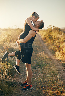 Buy stock photo Couple, fitness kiss hug outdoor on running path with lift and support with workout and exercise. Countryside, dirt road and happy people together with bonding, embrace and wellness in nature