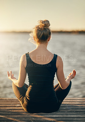 Buy stock photo Rearview shot of a young woman meditating outdoors