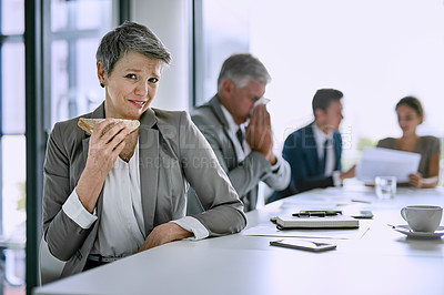 Buy stock photo Cropped shot of a businesswoman trying to eat her sandwich while a coworker blows his nose