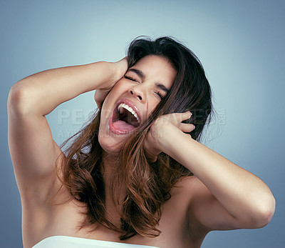 Buy stock photo Studio shot of a beautiful young woman screaming against a blue background