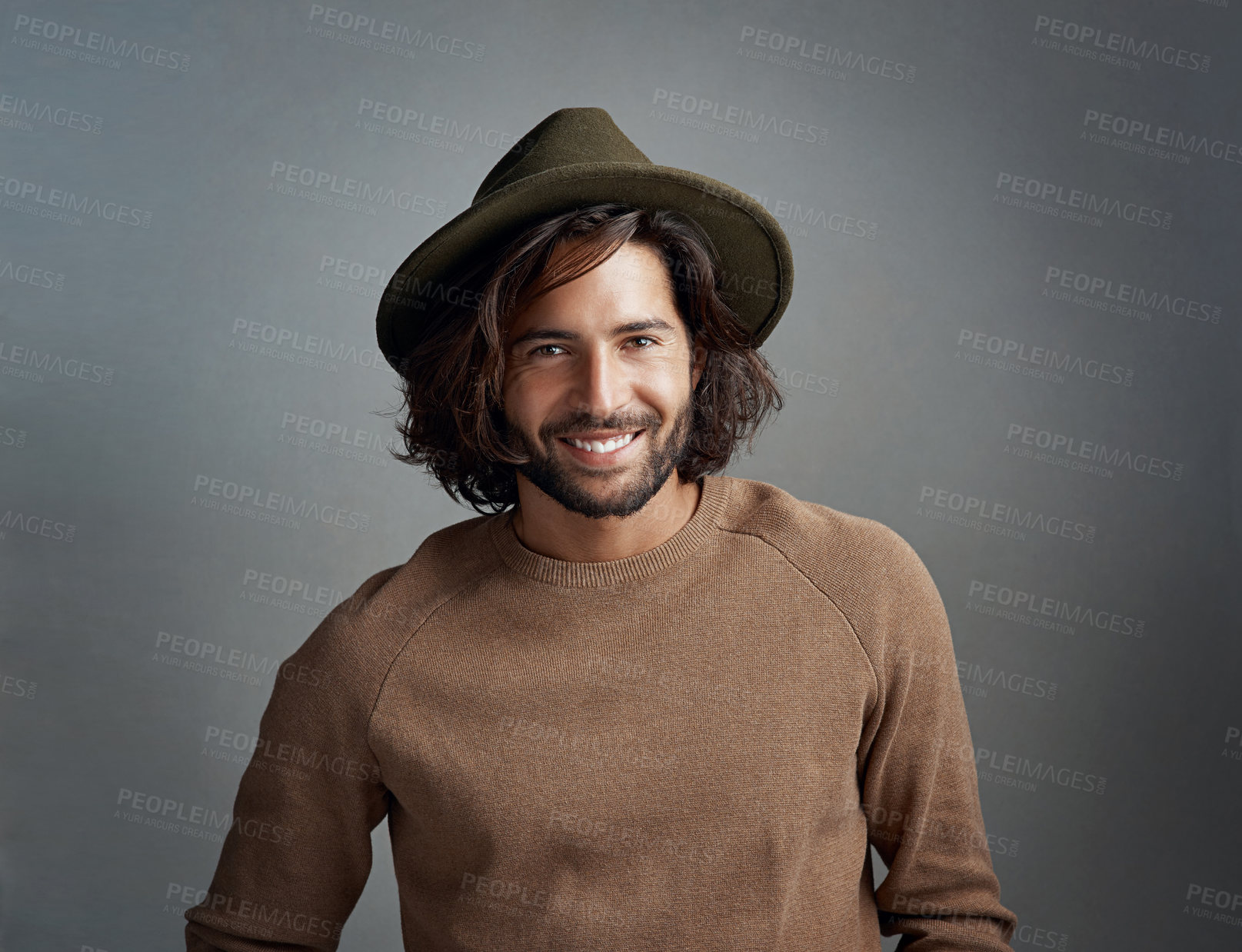 Buy stock photo Portrait, hat and smile of man in studio isolated on a gray background. Face, fedora and handsome male person or model from Australia with happiness for fashion, stylish and trendy aesthetic mockup.