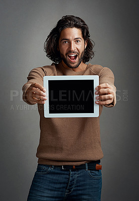 Buy stock photo Portrait, tablet screen and excited man with mockup in studio isolated on a gray background. Touchscreen, face and male person with marketing, advertising and technology for surprise promotion.
