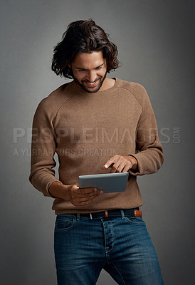 Buy stock photo Tablet, research and happy creative man in studio on grey background for scrolling information. Technology, social media or internet with smile of young website designer using online app to search