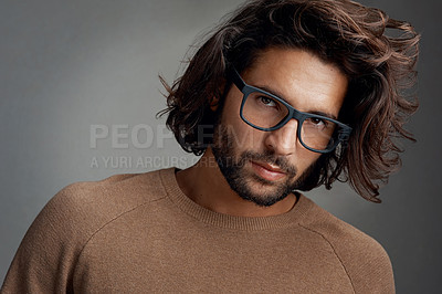 Buy stock photo Studio shot of a handsome young man wearing glasses against a gray background