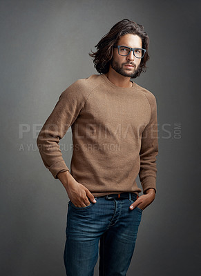 Buy stock photo Fashion, portrait and man in studio with style for trendy clothes, casual outfit or denim jeans on gray background. Cool, wardrobe and male model for designer glasses, winter jersey or confidence