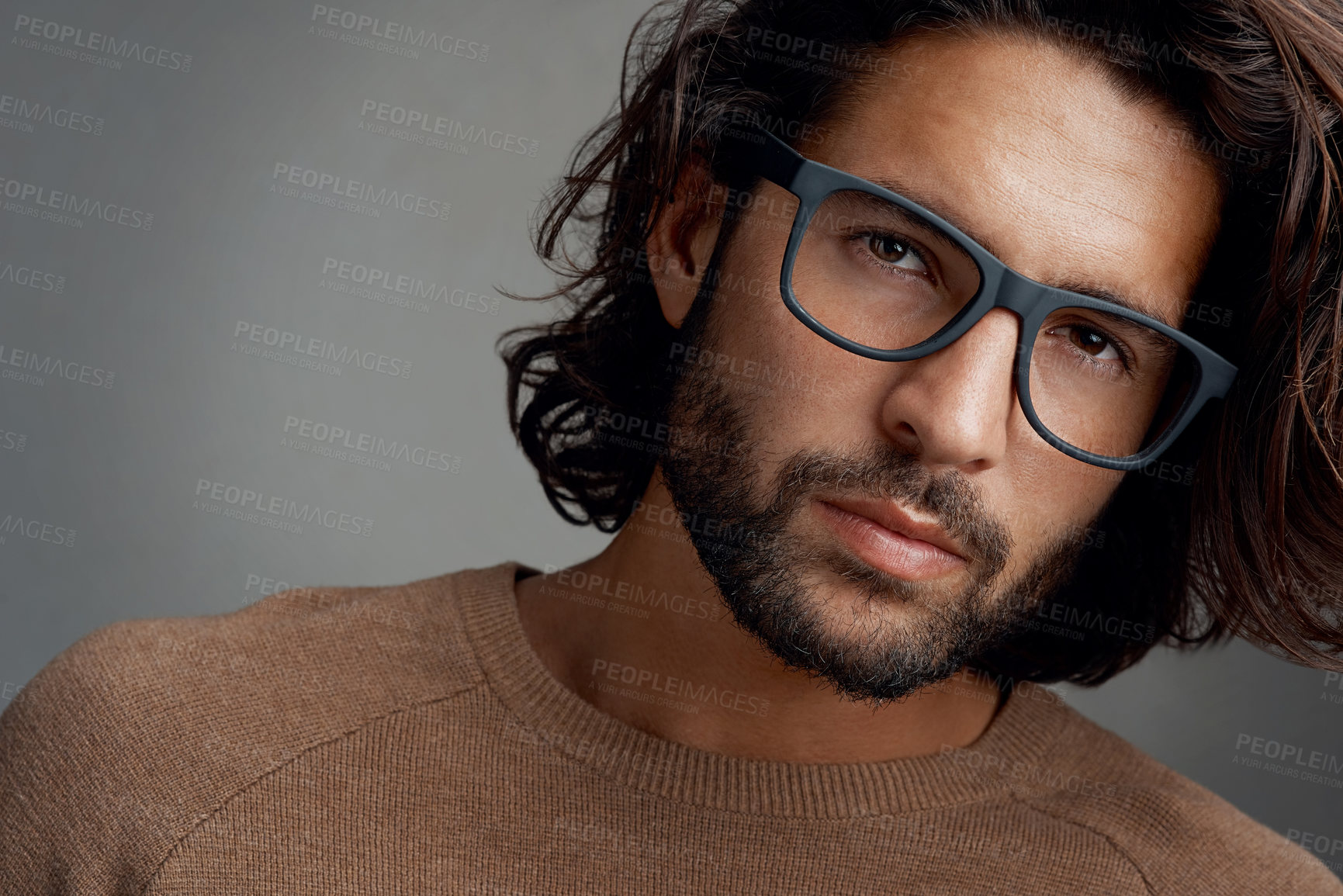 Buy stock photo Studio shot of a handsome young man wearing glasses against a gray background