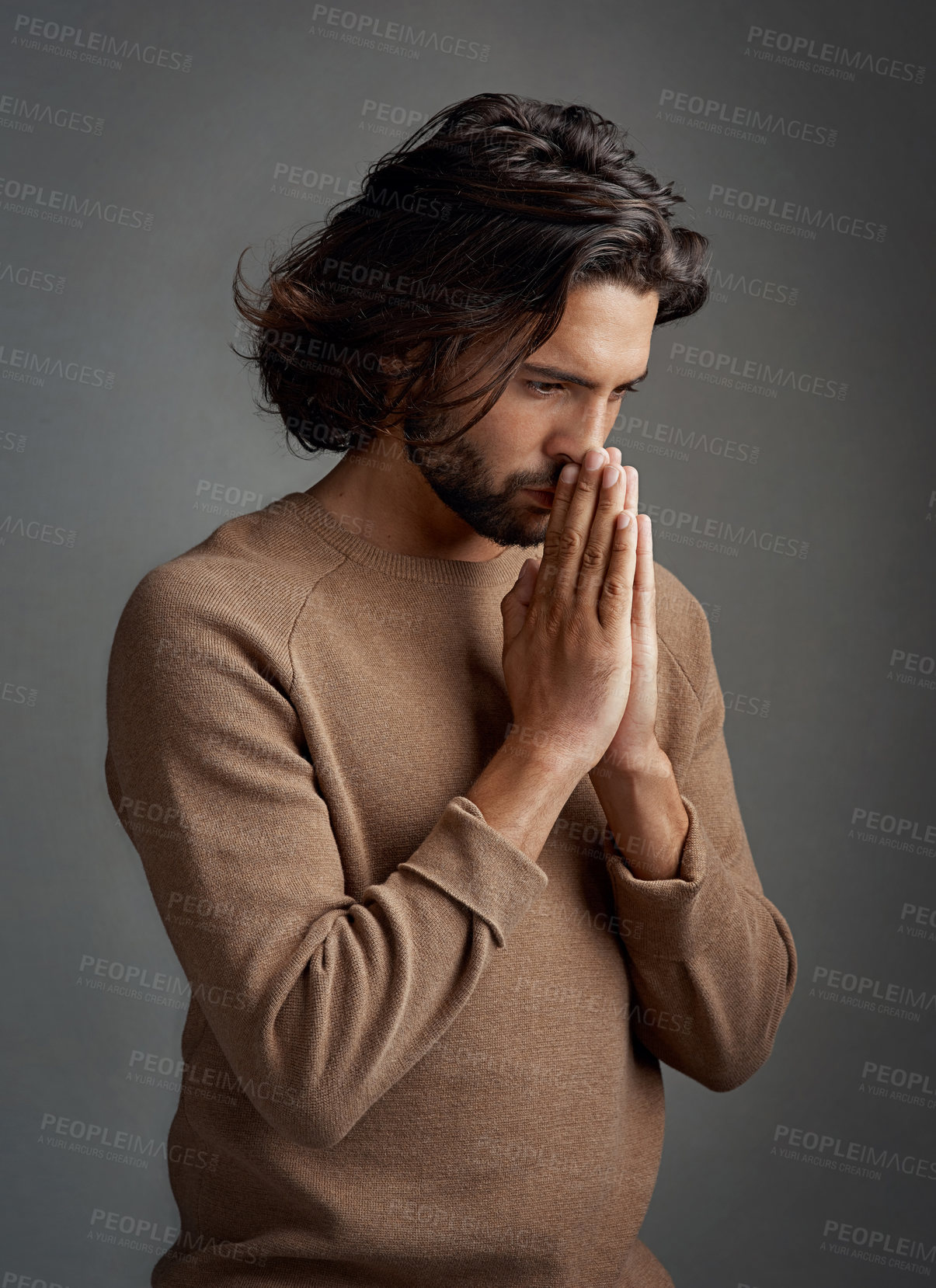 Buy stock photo Pray, faith and thinking with man in studio on a gray background asking god for miracle, help or answers. Trust, religion and spiritual with handsome, young guy and Christian praying belief in Jesus