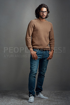 Buy stock photo Fashion, portrait and man in studio with glasses for trendy clothes, casual outfit or winter sweater on gray background. Style, wardrobe and male model for designer jersey, denim jeans or confidence