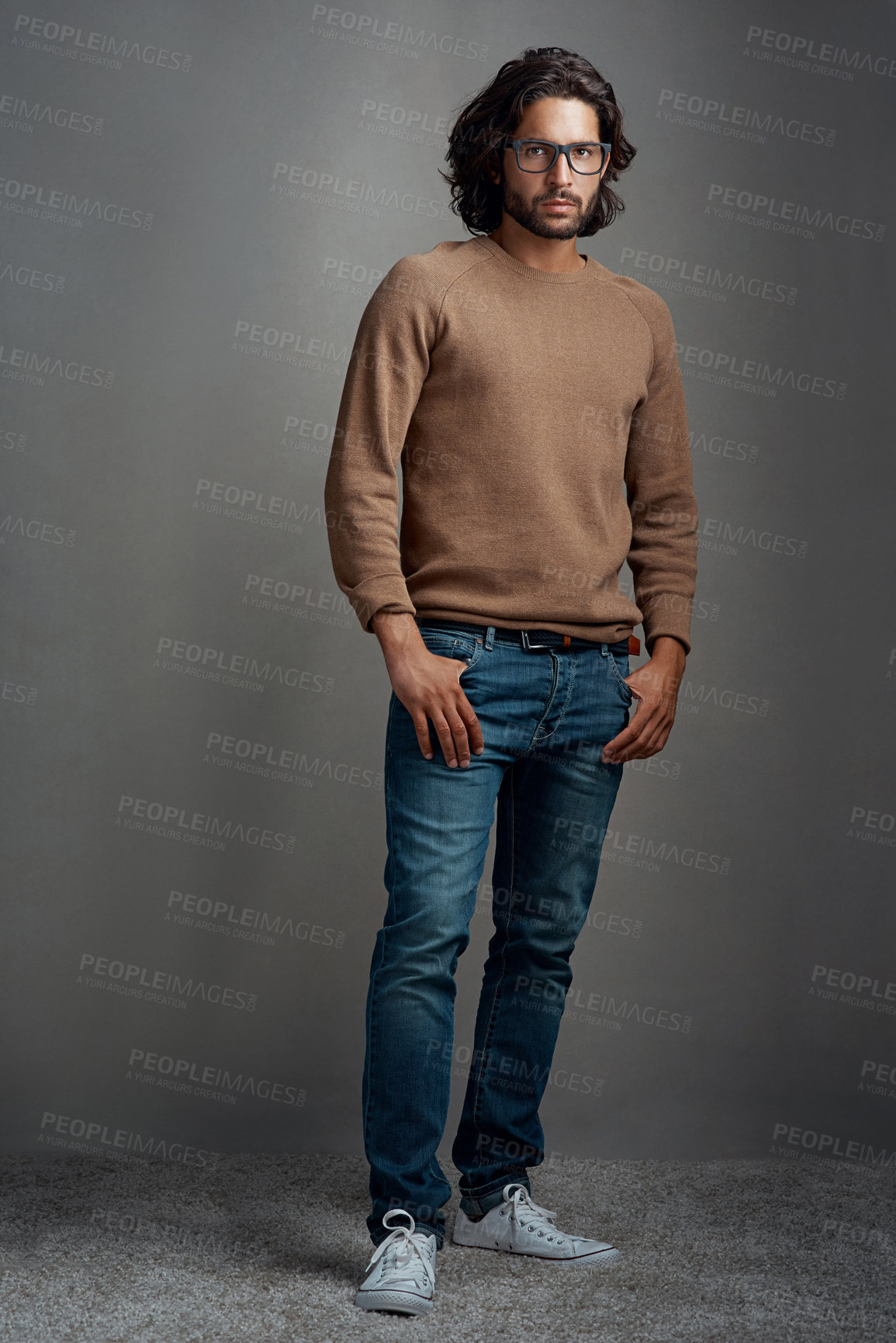 Buy stock photo Fashion, portrait and man in studio with glasses for trendy clothes, casual outfit or winter sweater on gray background. Style, wardrobe and male model for designer jersey, denim jeans or confidence