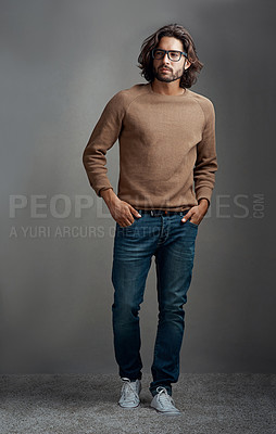 Buy stock photo Portrait, thinking and man with fashion studio for style ideas, comfortable or winter jeans clothes. Serious, male person and trendy jersey, designer glasses or hands in pocket on grey background