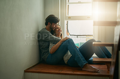 Buy stock photo Shot of an affectionate young couple at home